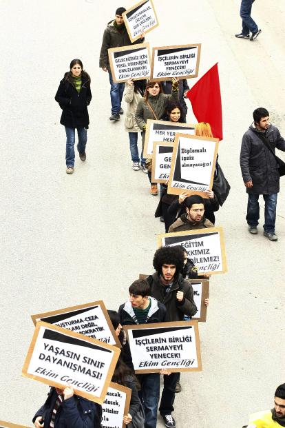 TEKEL workers brandish placards in protest to layoffs and the Turkish government's labor policy on the 68th day of their strike in Ankara on February 20, 2010. AFP PHOTO